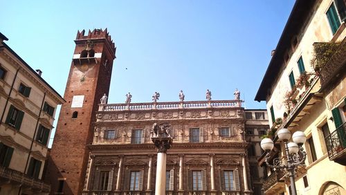 Low angle view of buildings against clear blue sky