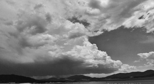 Scenic view of mountains against cloudy sky