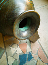 Close-up of machine part on tiled floor