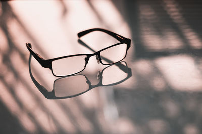 Close-up of eyeglasses on glass table in the office