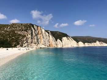 Scenic view of sea and mountains against sky