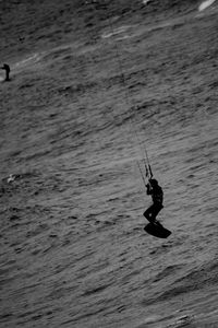 Full length of person kiteboarding over sea