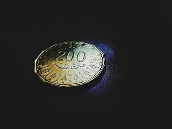 Close-up of clock over black background