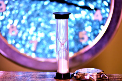 Close-up of illuminated electric lamp on table