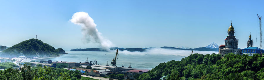 Panoramic view of buildings and sea against sky