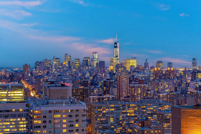 Illuminated cityscape against sky at night