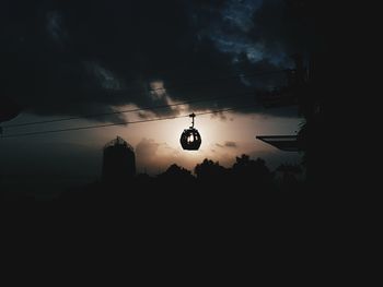 Low angle view of silhouette light against sky at sunset