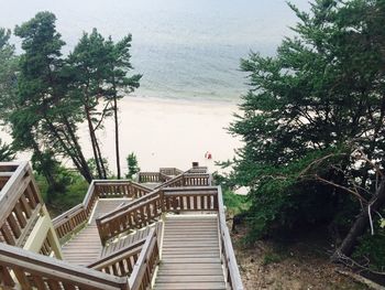 High angle view of staircase leading towards beach