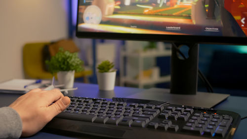 Midsection of person using laptop on table