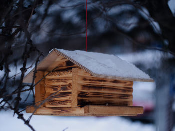 Close-up of birdhouse on snow covered land