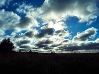 Scenic view of landscape against cloudy sky