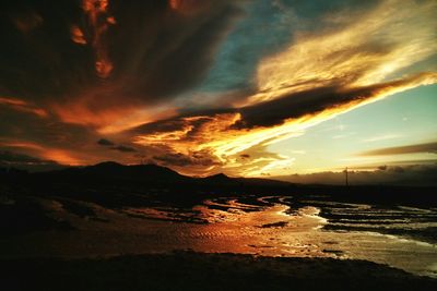 Scenic view of mountains against cloudy sky