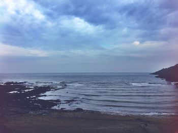 Scenic view of sea against cloudy sky