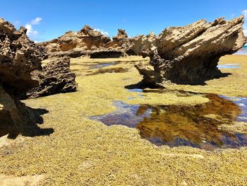 Scenic view of rocky landscape against blue sky