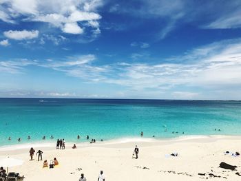 High angle view of people at beach against blue sky