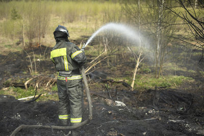 Rear view of man standing in forest