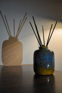 Close-up of drink in glass vase on table