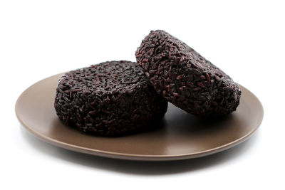 Close-up of dessert in plate against white background