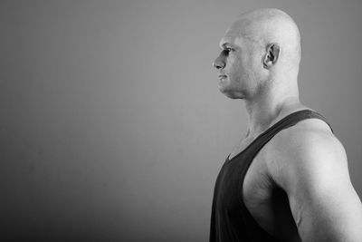 Portrait of man standing against wall