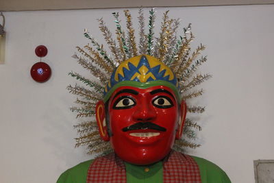 Portrait of man with red painting against wall