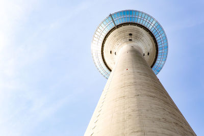 Low angle view of tower and building against sky