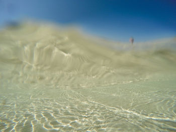 Surface level of sandy beach against sky