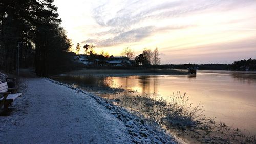 Scenic view of lake at sunset