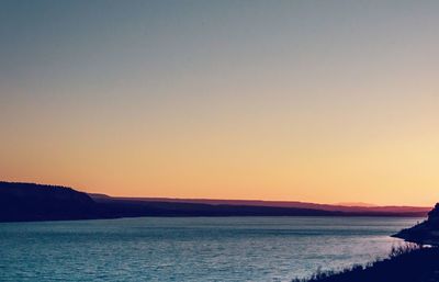 Scenic view of sea against clear sky during sunset