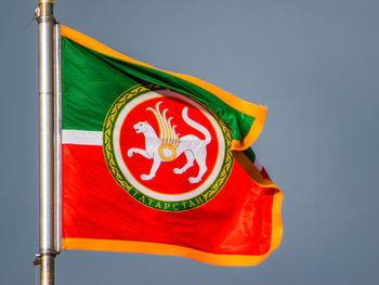 Low angle view of flag against blue sky