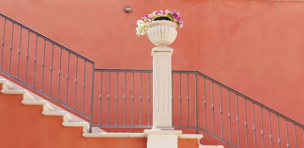 Low angle view of street light against wall