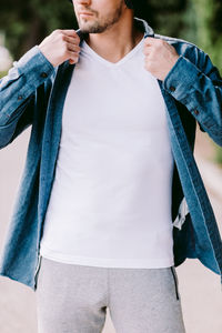 Midsection of man holding camera