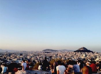 People at observation point against clear sky