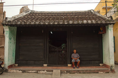 Full length of woman standing outside house