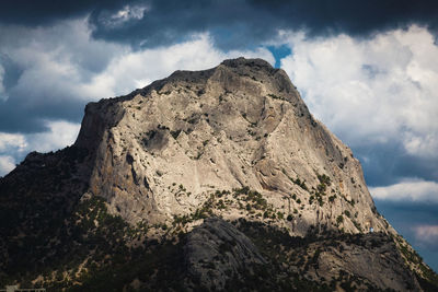 Low angle view of rock formation against sky