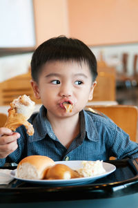 Close-up portrait of boy eating food