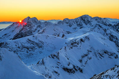 Scenic view of mountains against clear sky during sunset