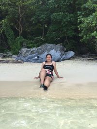 Portrait of young woman in water