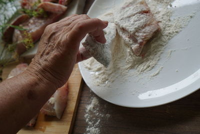 High angle view of person preparing food on table