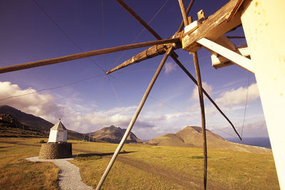 Traditional windmills against sky