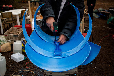 Low section of man working on metal