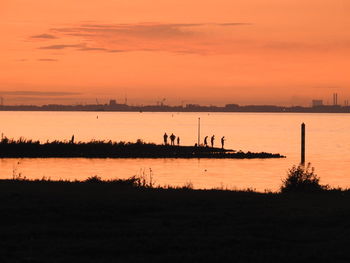 Scenic view of sea against orange sky