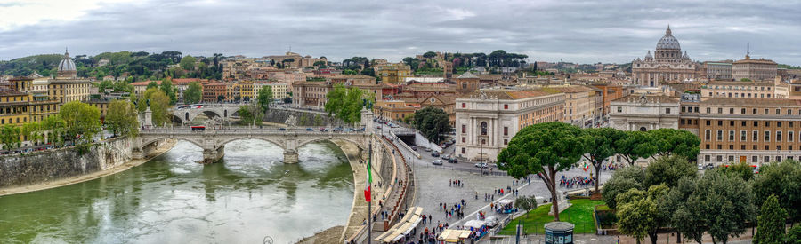Panoramic view of city buildings against cloudy sky
