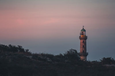 Tower of building against sky during sunset