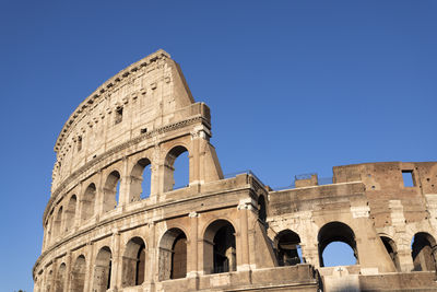 Low angle view of historical building against clear blue sky