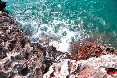 Waves splashing on rocks at shore