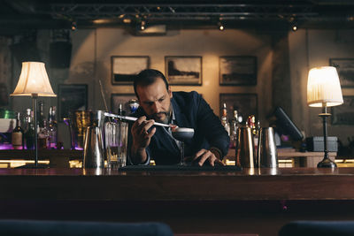 Full length of a man working in front of wooden table