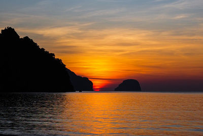 Scenic view of sea against romantic sky at sunset