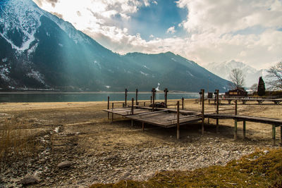 Scenic view of river and mountains against sky