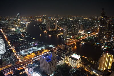 Aerial view of city lit up at night