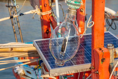 A halogen lamp with a solar battery charging station on the deck of a fisher boat